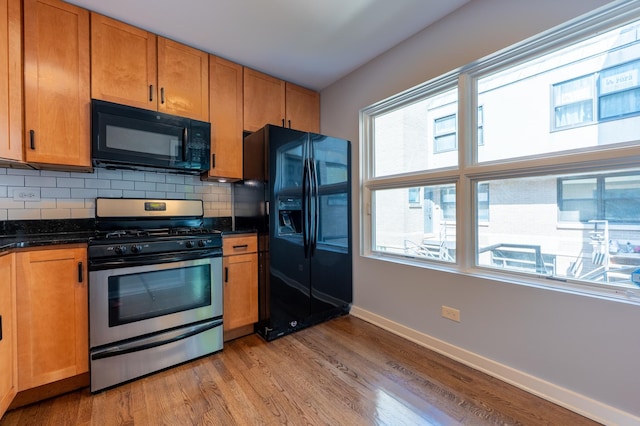 937 W Wrightwood Ave Unit C, Chicago, IL 60614 - kitchen with black appliances, light wood-style flooring, backsplash, and brown cabinetry