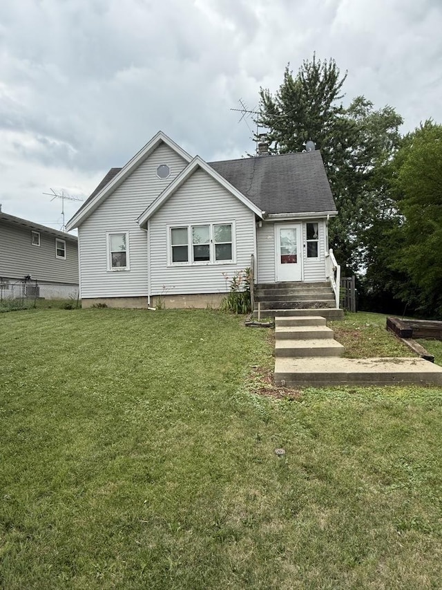 526 Grandview Dr, Round Lake Park, IL 60073 - view of front facade with a chimney, a front yard, and roof with shingles