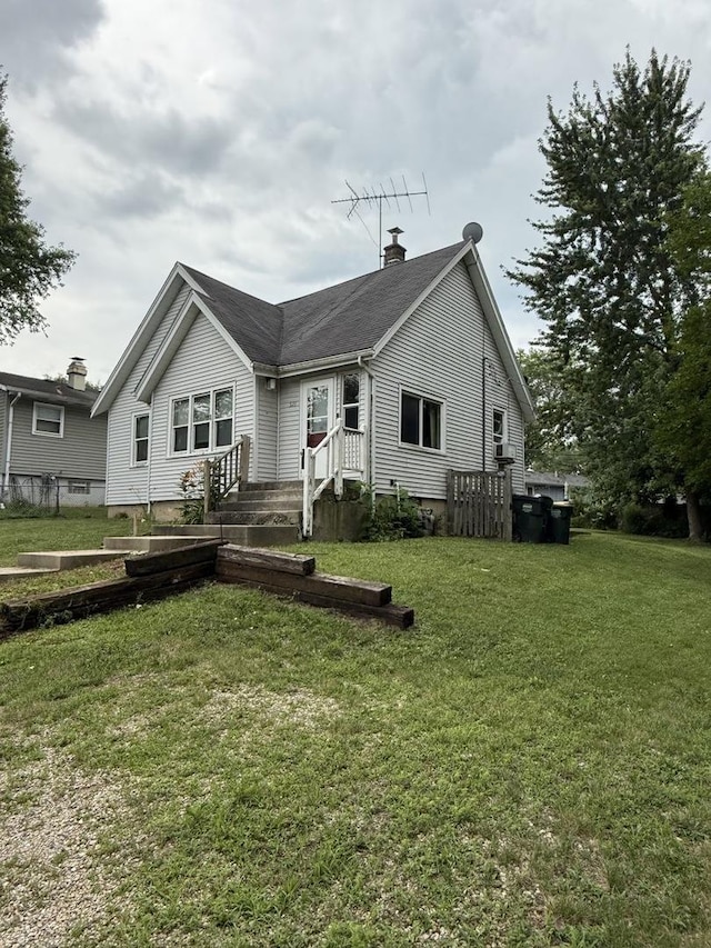 526 Grandview Dr, Round Lake Park, IL 60073 - rear view of property featuring a chimney and a yard