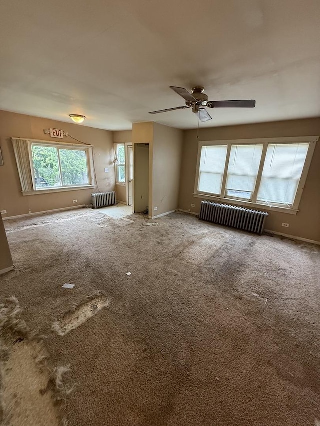 526 Grandview Dr, Round Lake Park, IL 60073 - unfurnished living room with radiator heating unit, carpet, and a ceiling fan