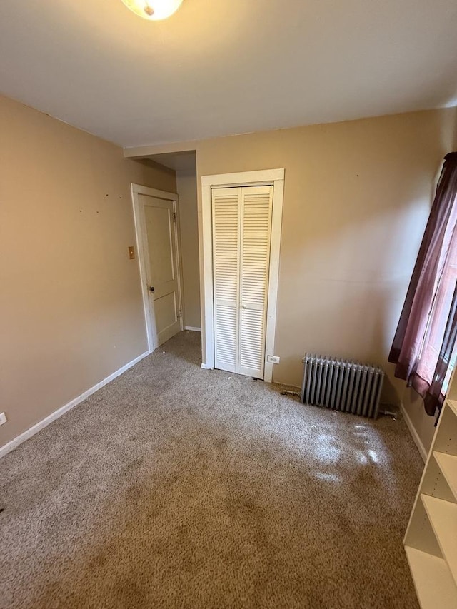 526 Grandview Dr, Round Lake Park, IL 60073 - unfurnished bedroom featuring radiator heating unit, carpet floors, and a closet