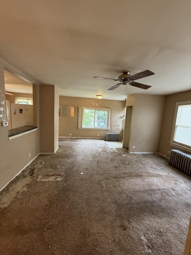 526 Grandview Dr, Round Lake Park, IL 60073 - unfurnished living room with radiator, ceiling fan, and carpet floors