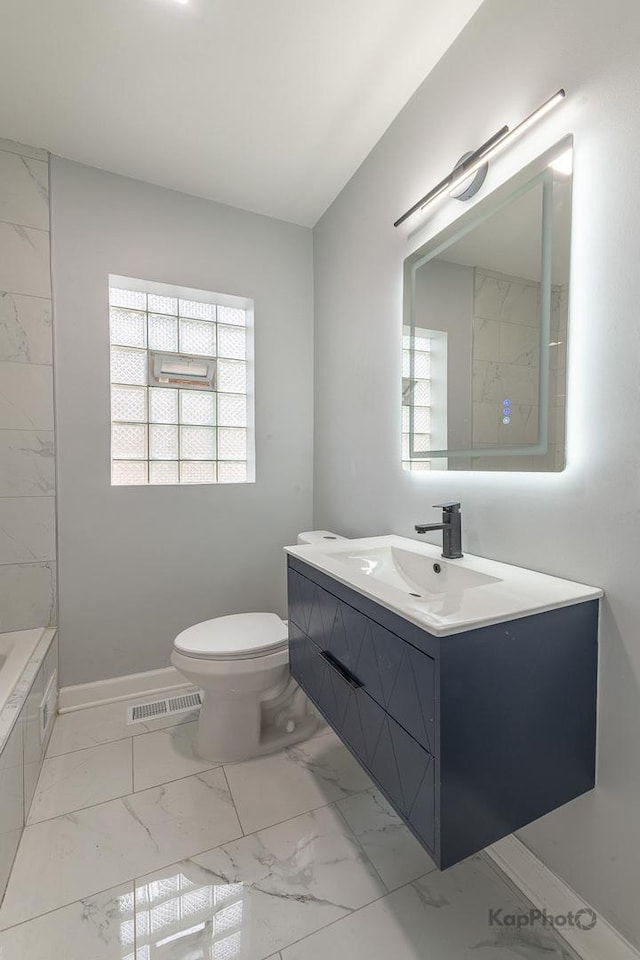 9340 S Elizabeth St, Chicago, IL 60620 - bathroom with marble look tiles, vanity, and healthy amount of natural light