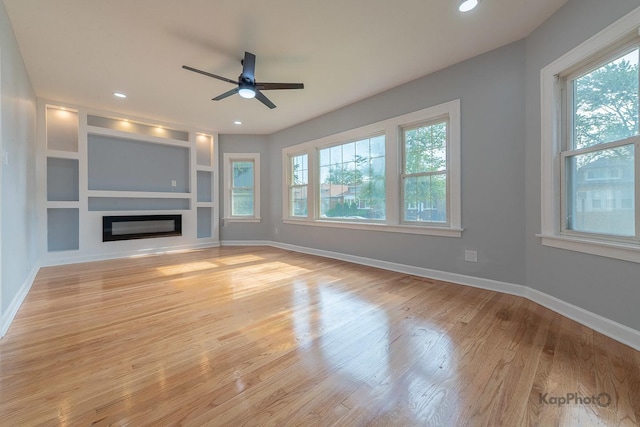 9340 S Elizabeth St, Chicago, IL 60620 - unfurnished living room with ceiling fan, light wood finished floors, a glass covered fireplace, built in shelves, and recessed lighting