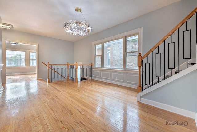 9340 S Elizabeth St, Chicago, IL 60620 - spare room featuring light wood-style flooring and a chandelier