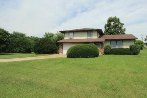 8315 Nolan St, Harvard, IL 60033 - split level home featuring an attached garage, a front yard, and driveway