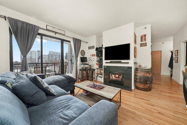 41 E 8th St Unit 1404, Chicago, IL 60605 - living area featuring wood finished floors and a fireplace with flush hearth