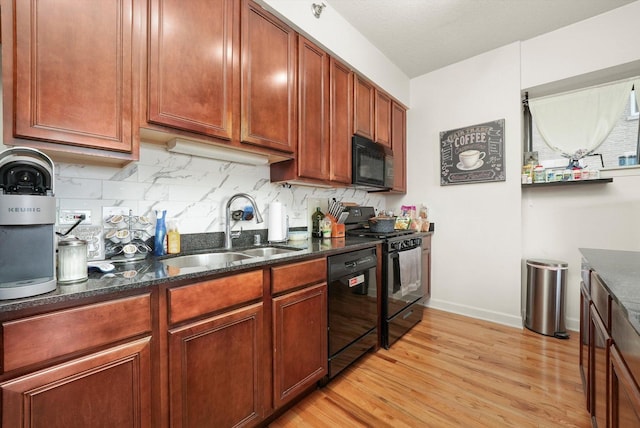 41 E 8th St Unit 1404, Chicago, IL 60605 - kitchen featuring black appliances, light wood-style floors, dark stone counters, and tasteful backsplash