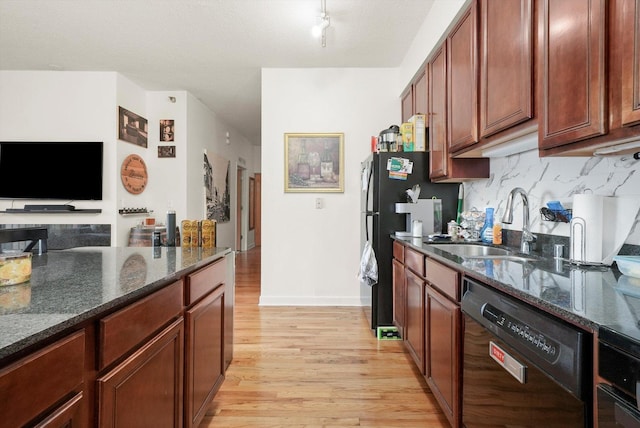 41 E 8th St Unit 1404, Chicago, IL 60605 - kitchen featuring black appliances, light wood-style flooring, dark stone counters, and decorative backsplash