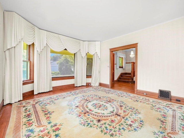 31 Bluff Ave, La Grange, IL 60525 - spare room featuring wood finished floors, ornamental molding, and stairway