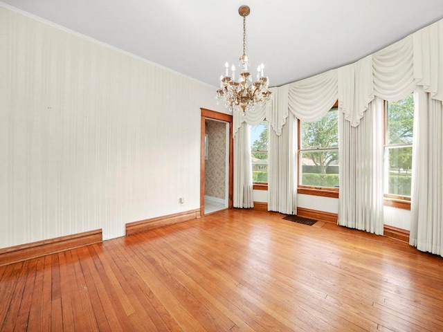 31 Bluff Ave, La Grange, IL 60525 - empty room featuring a chandelier, light wood-style flooring, and ornamental molding