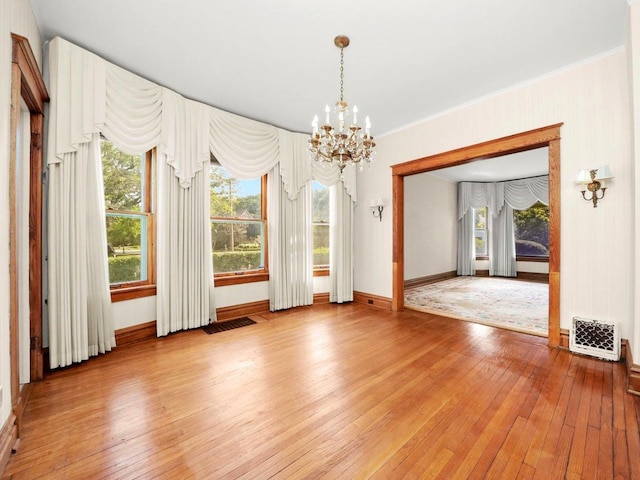 31 Bluff Ave, La Grange, IL 60525 - spare room featuring a chandelier, light wood finished floors, and healthy amount of natural light