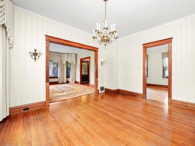 31 Bluff Ave, La Grange, IL 60525 - empty room featuring light wood-style floors, a chandelier, and ornamental molding