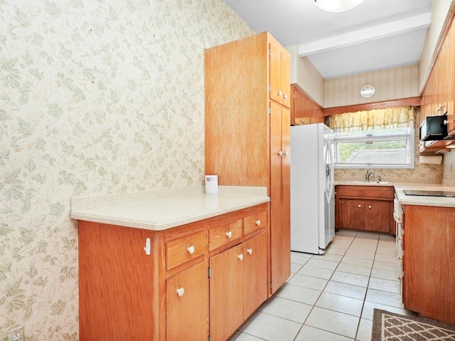 31 Bluff Ave, La Grange, IL 60525 - kitchen featuring wallpapered walls, white refrigerator with ice dispenser, light countertops, light tile patterned floors, and brown cabinetry