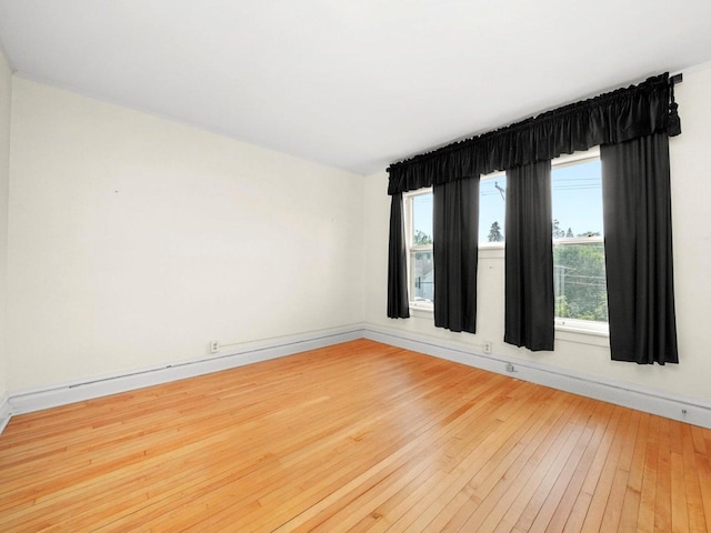 31 Bluff Ave, La Grange, IL 60525 - spare room featuring light wood-style floors and a baseboard radiator