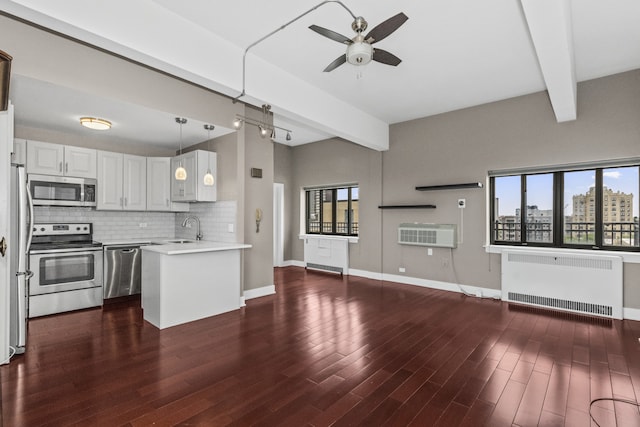 5048 N Marine Dr Unit A9, Chicago, IL 60640 - kitchen featuring stainless steel appliances, beam ceiling, ceiling fan, radiator heating unit, and decorative backsplash