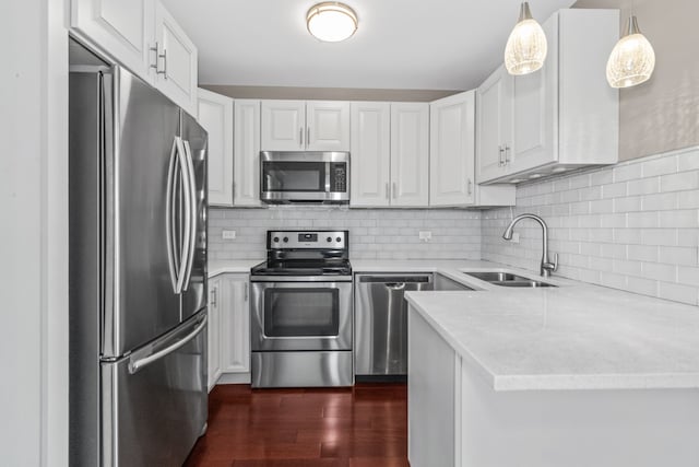 5048 N Marine Dr Unit A9, Chicago, IL 60640 - kitchen featuring stainless steel appliances, dark wood-style floors, white cabinetry, decorative backsplash, and decorative light fixtures