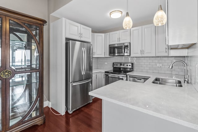 5048 N Marine Dr Unit A9, Chicago, IL 60640 - kitchen featuring stainless steel appliances, light countertops, dark wood finished floors, tasteful backsplash, and hanging light fixtures