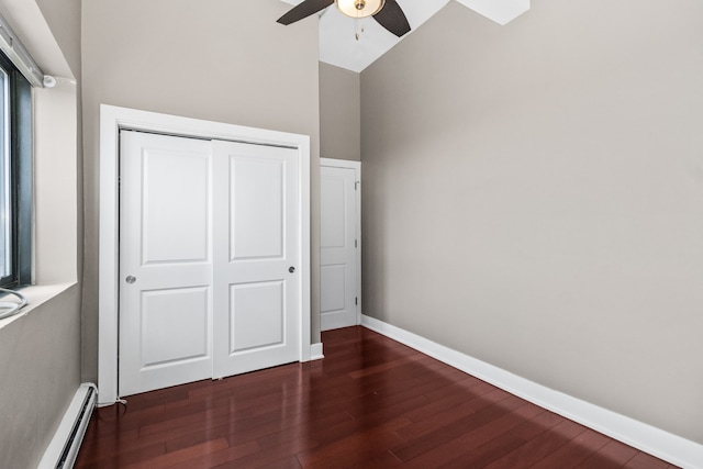 5048 N Marine Dr Unit A9, Chicago, IL 60640 - unfurnished bedroom featuring a baseboard radiator, wood finished floors, a closet, and a ceiling fan