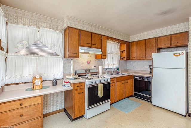 3855 W 107th St, Chicago, IL 60655 - kitchen with white appliances, under cabinet range hood, brown cabinets, light flooring, and wallpapered walls