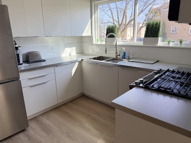 9003 Bronx Ave, Skokie, IL 60077 - kitchen featuring freestanding refrigerator, modern cabinets, and light wood-style floors