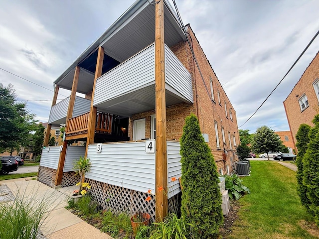 9003 Bronx Ave, Skokie, IL 60077 - view of front of house with brick siding, a front lawn, and a balcony