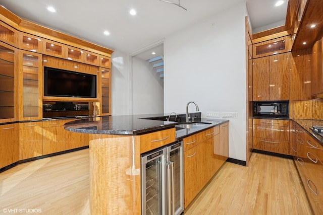 65 W Schiller St, Chicago, IL 60610 - kitchen with wine cooler, light wood finished floors, black microwave, dark stone countertops, and modern cabinets