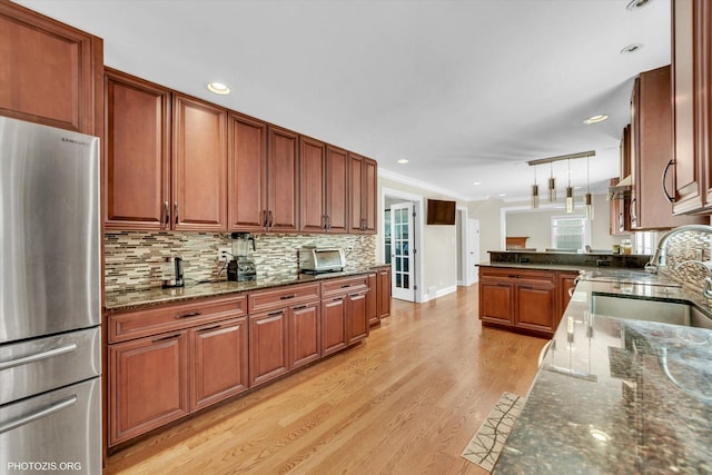 950 Belmar Ln, Buffalo Grove, IL 60089 - kitchen featuring freestanding refrigerator, light wood finished floors, dark stone counters, ornamental molding, and a peninsula