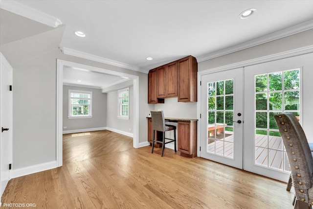 950 Belmar Ln, Buffalo Grove, IL 60089 - kitchen featuring french doors, crown molding, brown cabinetry, light wood-style flooring, and a kitchen breakfast bar