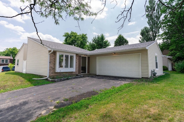 129 Highbury Dr, Elgin, IL 60120 - ranch-style home featuring a garage, brick siding, asphalt driveway, and a front lawn