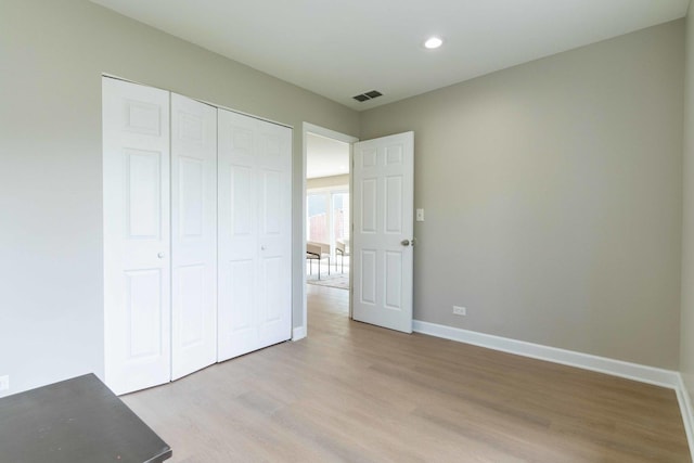 129 Highbury Dr, Elgin, IL 60120 - unfurnished bedroom with light wood-style flooring, recessed lighting, and a closet