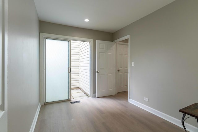 129 Highbury Dr, Elgin, IL 60120 - unfurnished bedroom with wood finished floors and recessed lighting