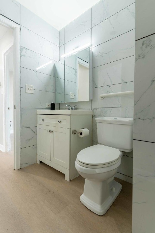 129 Highbury Dr, Elgin, IL 60120 - bathroom with vanity, wood finished floors, and tile walls