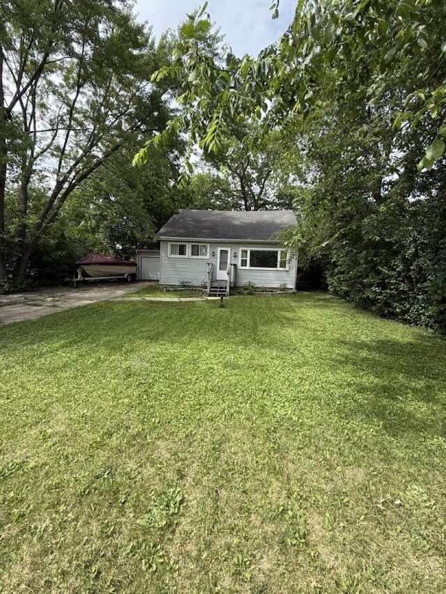 24576 W Norelius Ave, Round Lake, IL 60073 - view of front of house featuring driveway, an attached garage, a front yard, and entry steps