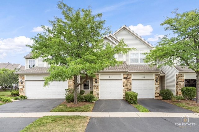 951 Viewpoint Dr, Lake In The Hills, IL 60156 - view of front of house with a shingled roof, stone siding, and driveway