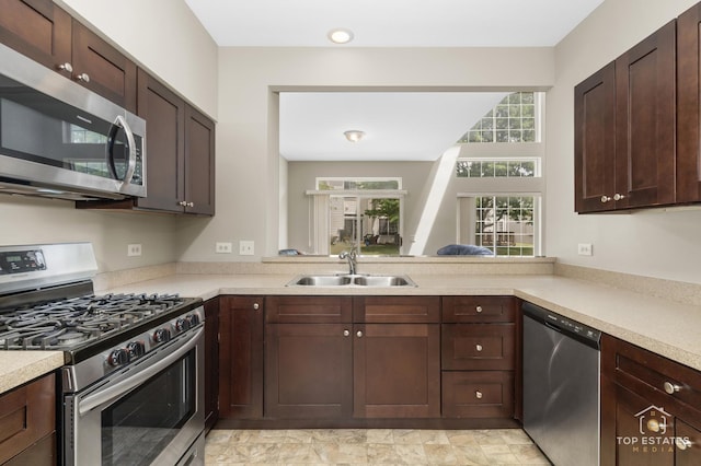 951 Viewpoint Dr, Lake In The Hills, IL 60156 - kitchen with appliances with stainless steel finishes, light countertops, and dark brown cabinetry