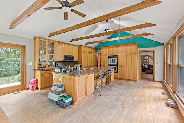 3457 W Hamilton Rd, Monee, IL 60449 - kitchen with stainless steel double oven, ceiling fan, and light wood-style flooring