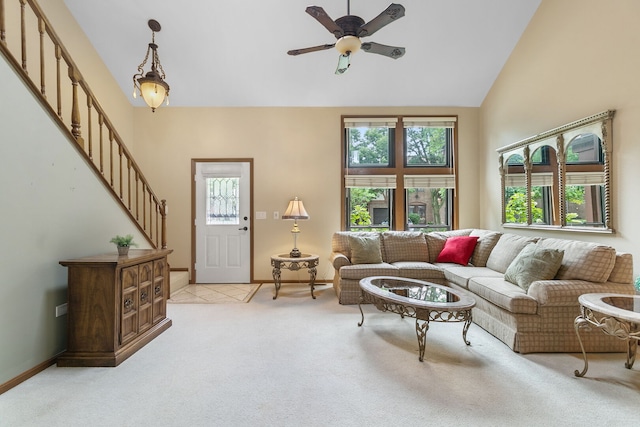 11016 Eaton Ct, Westchester, IL 60154 - living area with healthy amount of natural light, light colored carpet, high vaulted ceiling, a ceiling fan, and stairway
