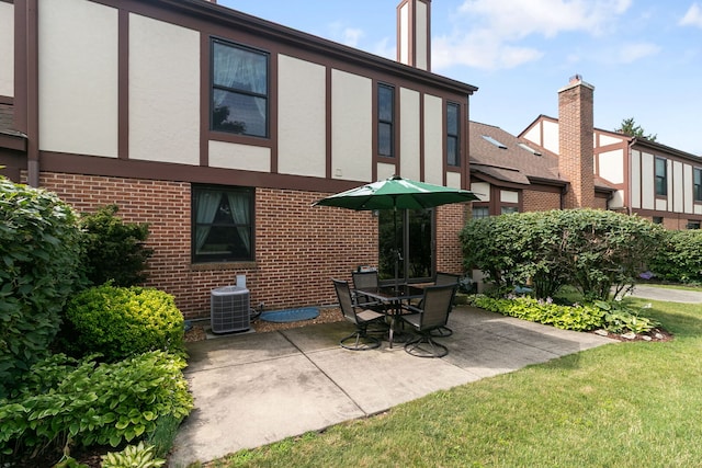 11016 Eaton Ct, Westchester, IL 60154 - rear view of house featuring stucco siding, brick siding, and a patio area