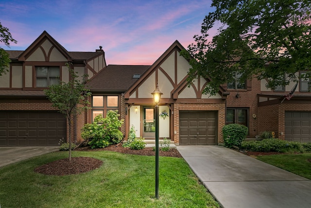 11016 Eaton Ct, Westchester, IL 60154 - english style home with concrete driveway, brick siding, stucco siding, a garage, and a lawn