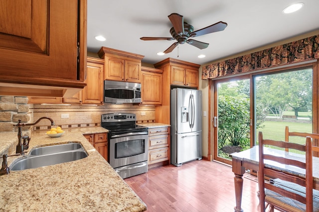 11016 Eaton Ct, Westchester, IL 60154 - kitchen with appliances with stainless steel finishes, a ceiling fan, decorative backsplash, light wood-type flooring, and recessed lighting