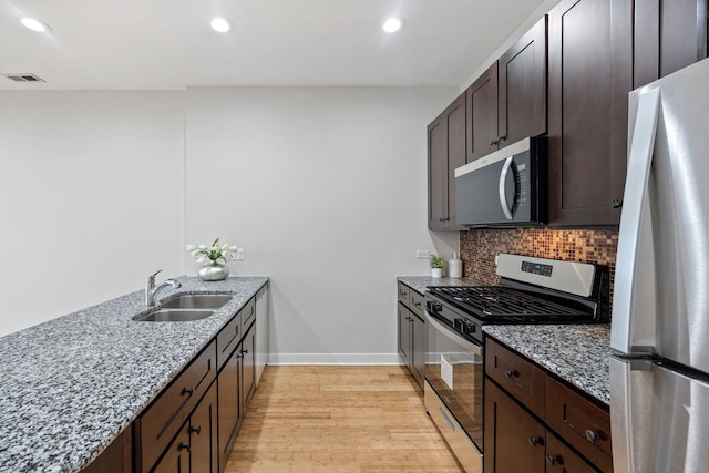 3130 W Walton St Unit 3, Chicago, IL 60622 - kitchen with gas stove, freestanding refrigerator, light stone counters, light wood finished floors, and recessed lighting