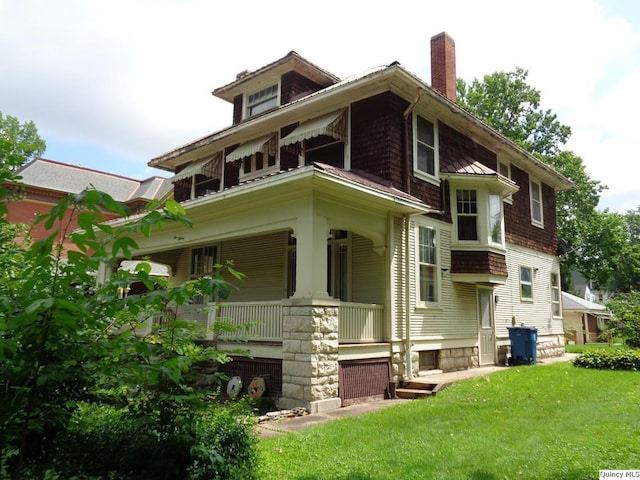 215 S 16th St, Quincy, IL 62301 - view of front facade with a porch, a chimney, and a front yard