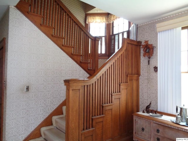 215 S 16th St, Quincy, IL 62301 - staircase featuring wallpapered walls, healthy amount of natural light, and a chandelier