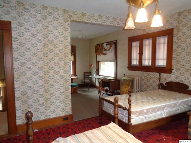 215 S 16th St, Quincy, IL 62301 - bedroom featuring wallpapered walls, radiator heating unit, and carpet