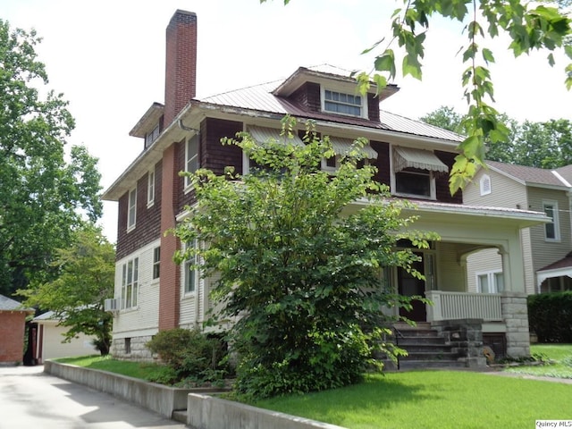 215 S 16th St, Quincy, IL 62301 - view of front of property featuring covered porch, a metal roof, an outdoor structure, a chimney, and a garage