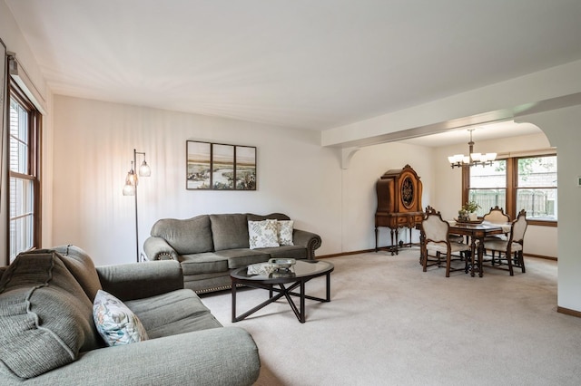 872 Asbury Ln, Schaumburg, IL 60193 - living room with a chandelier, light colored carpet, and arched walkways