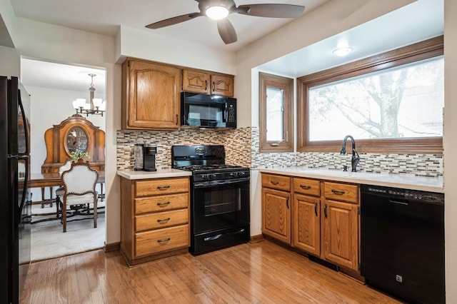 872 Asbury Ln, Schaumburg, IL 60193 - kitchen featuring black appliances, light countertops, brown cabinetry, and ceiling fan