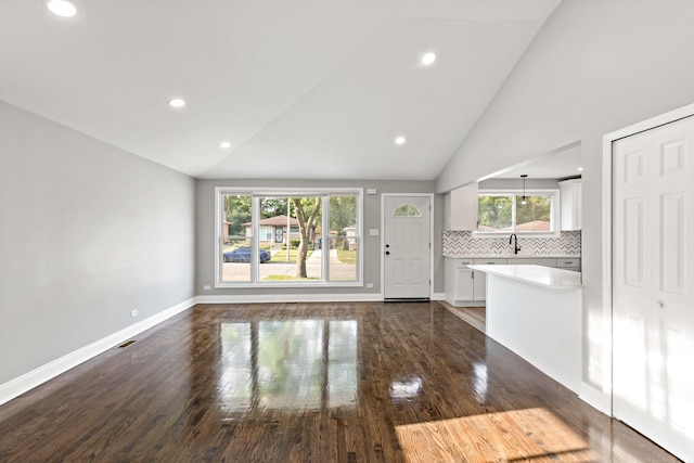 293 Hickory St, Chicago Heights, IL 60411 - unfurnished living room with vaulted ceiling, dark wood-style flooring, and recessed lighting