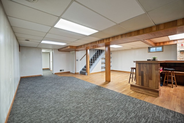267 N Idlewild Ave, Mundelein, IL 60060 - below grade area with a bar, stairway, wood finished floors, and a drop ceiling